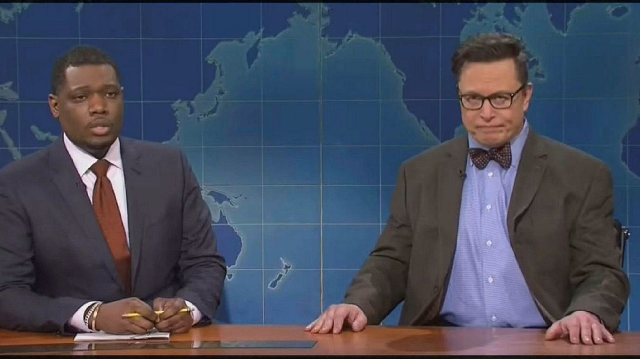 2 actors pretending to be news presenters on SNL. One is Elon Musk.
