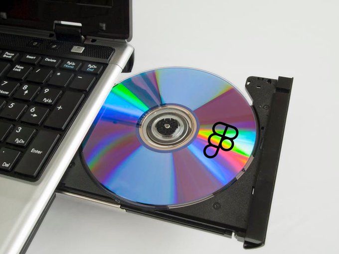 CD inserted into a laptop CD drive with a figma logo